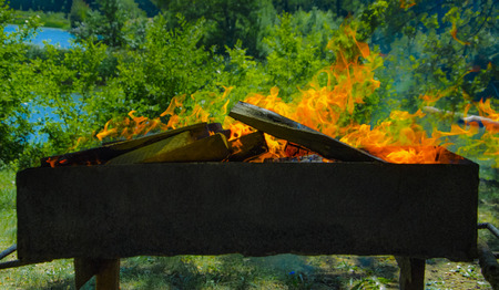 Brazier with burning coals. Burned firewood in the grill.の写真素材