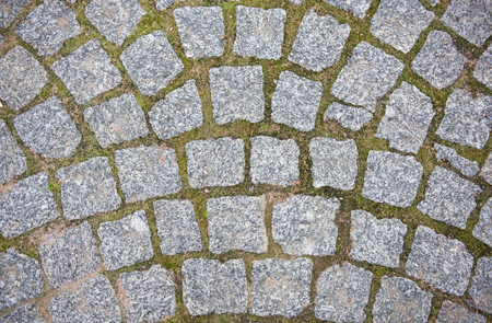 Stone pavement texture. Granite cobblestoned pavement background. Abstract background of old cobblestone pavement close-up.の写真素材