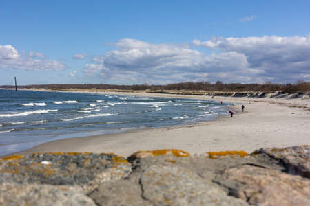 Sandy beach on the cold Baltic Sea. A clear sunny day with a blue sky with clouds in Baltiysk, Kalinigrad region, Russia.の写真素材