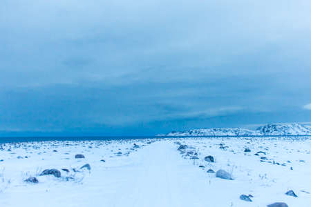 Snow plains on the Barents sea coast beyond the Arctic circle in the far North in the Murmansk region the village of Teriberka in the cold winterの写真素材