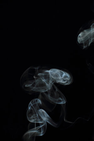 Abstract white smoke texture on black backgroundの写真素材