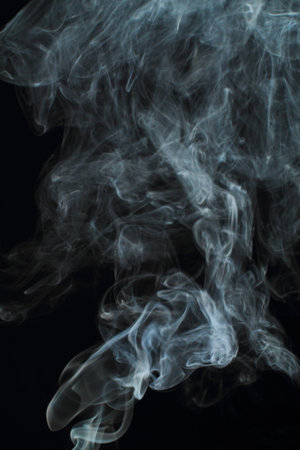 Abstract white smoke texture on black backgroundの写真素材