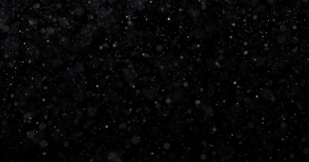 Falling snowflakes on black background. Snowfall in the night sky.の写真素材