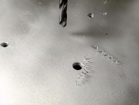 drilling holes in the metallic boardの写真素材