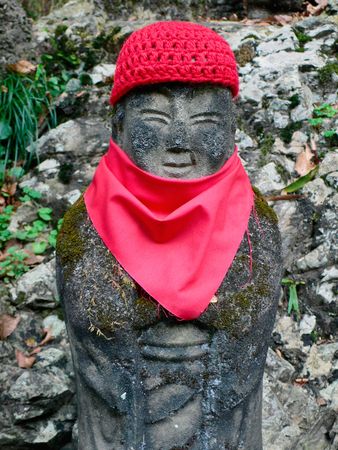 traditional statue of japanese jizo (goodwill deity) on the forest wayの写真素材