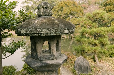 ancient stone lantern in traditional Japanese zen garden in Kyoto, Japan; focus on lanternの写真素材