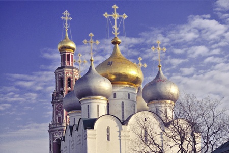 golden crosses and domes of Smolenski Cathedral and bell-tower of famous Novodevichy Convent in...