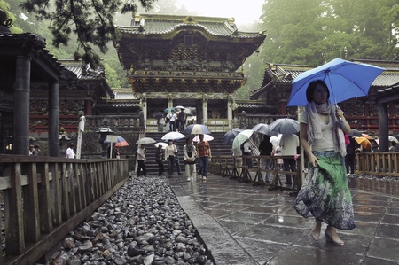 Nikko, Tochigi, Japan - June 22, 2008: Visitors walks under rain on the place of famous Toshogu shrine. The Toshogu is famous as a mausoleum of Tokugawa Ieyasu, founder of the Tokugawa shogunate, which ruled Japan for over 250 years until 1868.のeditorial素材