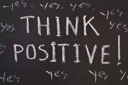 think positive concept handwritten on black chalkboard の写真素材