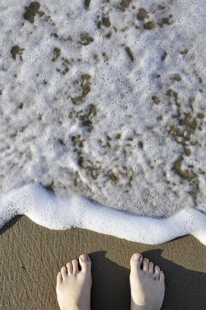 meeting with the sea surf; focus on legsの写真素材