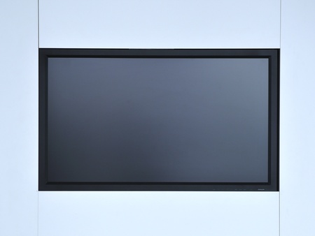 blank monitor screen hanged on white wall