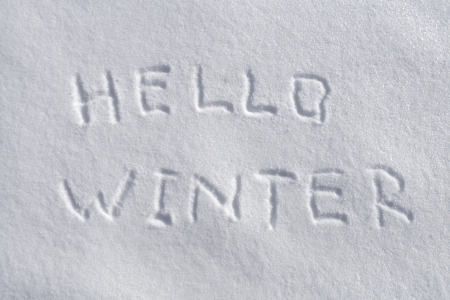handwritten Hello Winter on the fresh snow backgroundの写真素材