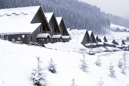 winter street in alpine village under snowfall