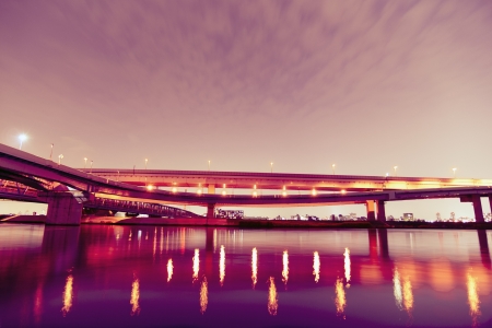 night highway with light reflections over Arakawa river in Tokyo Japanの写真素材