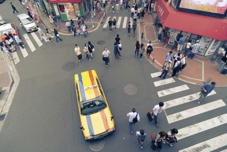 Tokyo, Japan - September 01,  2007: Pedestrians walk on many zebra crossings around taxi car in famous Shinjuku district in Tokyo, Japanのeditorial素材