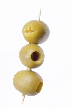 three pitted green olives on wooden stickの写真素材