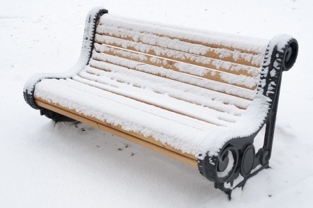 park bench covered by snowの写真素材