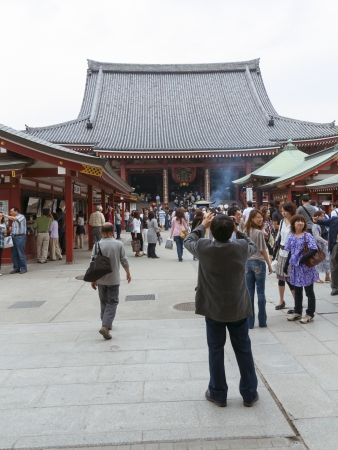 Tokyo, Japan - May 24, 2008: man takes a photo inside inner yard of Sens?-ji  also known as Asakusa Kannon Temple. Sens?-ji is one of most scenic and popular Tokyo Buddhist temples.のeditorial素材