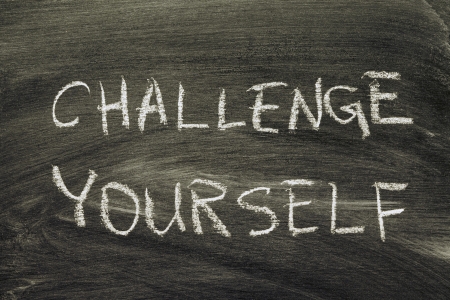challenge yourself phrase handwritten on school blackboardの写真素材