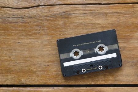vintage hi-end audio cassette on cracked wooden tableの写真素材