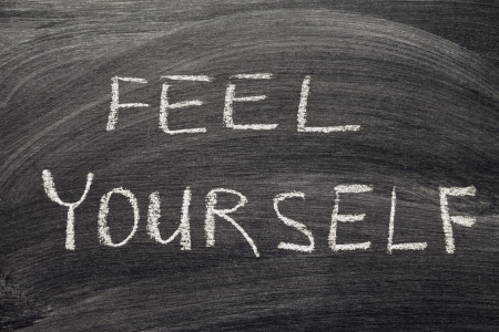 feel yourself phrase handwritten on school blackboardの写真素材