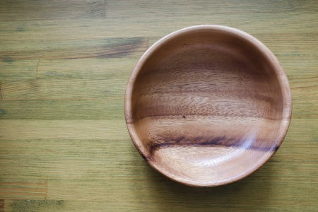 empty wooden bowl on green wooden tableの写真素材