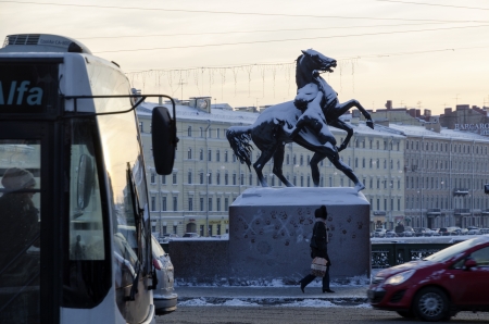 St.Petersburg, Russia - December 26, 2012: Winter traffic on the Anichkov bridge on Nevsky Prospect at twilight time. There is famous Horse Tamers statue under snow at the opposite side of the street.のeditorial素材