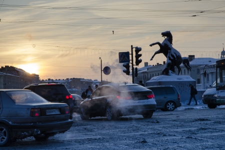 St.Petersburg, Russia - December 26, 2012: Winter traffic on the Anichkov bridge on Nevsky Prospect at twilight time. There is famous Horse Tamers statue under snow at the opposite side of the street.のeditorial素材