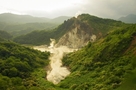 summer landscape with hot steam volcanic activity in Noboribetsu area of Hokkaido island in Japanの写真素材