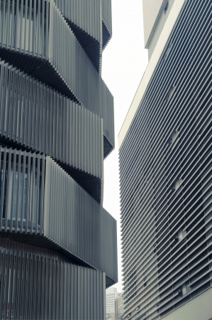 tight urban space between modern buildingsの写真素材