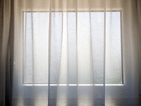 transparent curtain with small window behindの写真素材