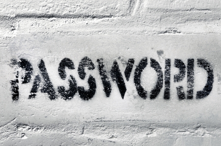 textured black stencil print of password question on the weathered white brick wallの写真素材