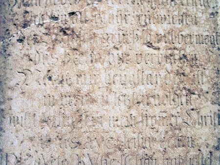 fragment of medieval wall with carved letters from Frauenkirche building in Munich, Germanyの写真素材