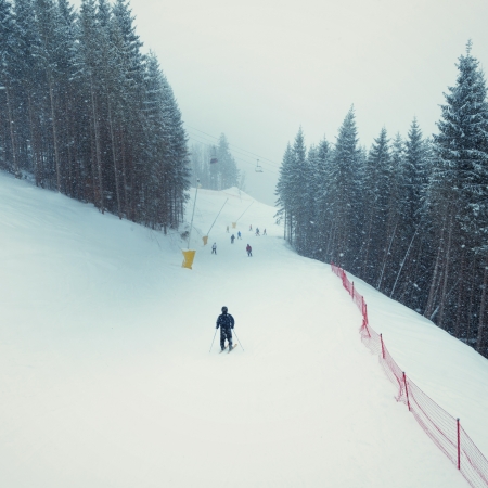 ski men  going down on ski resort trackの写真素材
