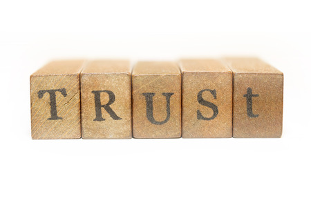trust word made from wooden bricks isolated on white