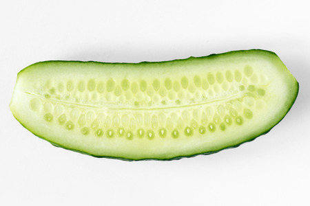 fresh ripe half cucumber cut on white backgroundの写真素材