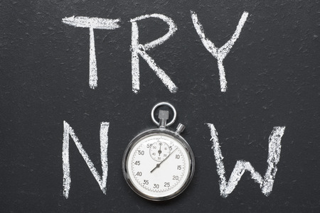 try now concept handwritten on chalkboard with vintage precise stopwatch used instead of Oの写真素材