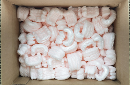 carton packing box with pink packaging filling insideの写真素材