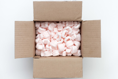 carton packing box wide open with pink packaging filling inside
