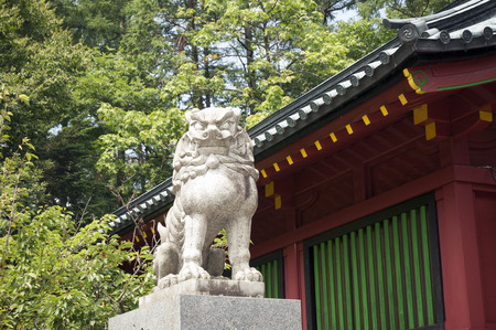 stone sculpture of lion guard near Japanese temple wallのeditorial素材