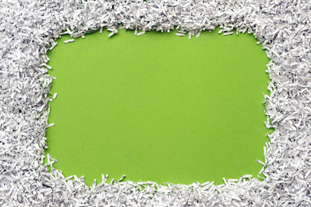 green background with shredded paper frame aroundの写真素材