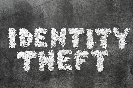 identity theft phrase made from shredded paper on blackboard surfaceの写真素材