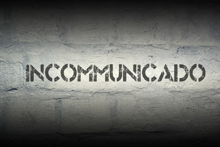 incommunicado stencil print on the grunge white brick wall
