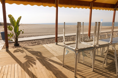 wooden deck patio on the empty sand beachの写真素材