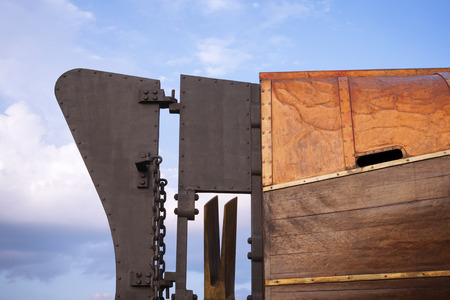 fragment of tail blade from vintage submarine vessel with blue sky behindの写真素材