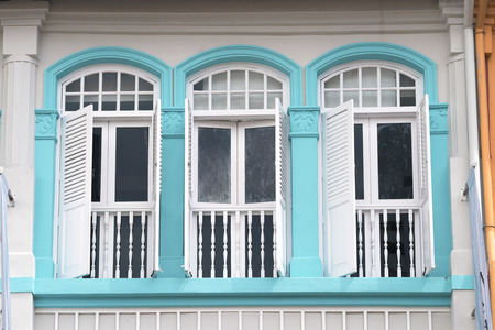 traditional decorated windows with wooden  shutters of old building in Singapore Chinatownのeditorial素材