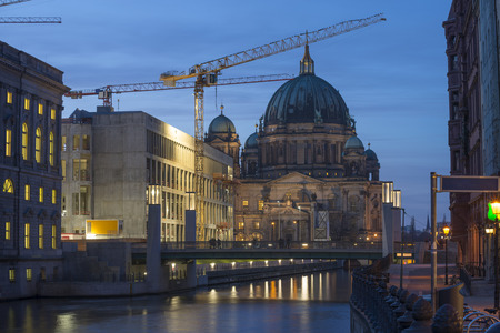 twilight at the Spree river with view to the Berliner Dom Cathedral through construction siteの写真素材