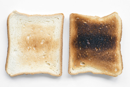 low and hard fried toasts isolated on whiteの写真素材