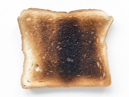 hard burned toast isolated on whiteの写真素材