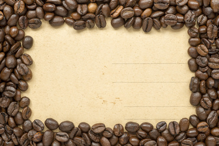 vintage postcard arranged by roasted coffee beans as picture frameの写真素材